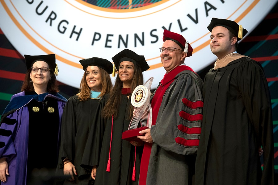 Faculty Senate Chair Jeanne VanBriesen, Student Body President Roshni Mehta, Staff Council President Jessica Owens and Alumni Association President Alex DiClaudio presented Jahanian with a commemorative sculpture 