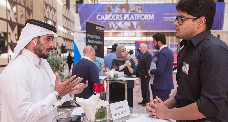 A representative from QatarGas meets with a CMU-Q student