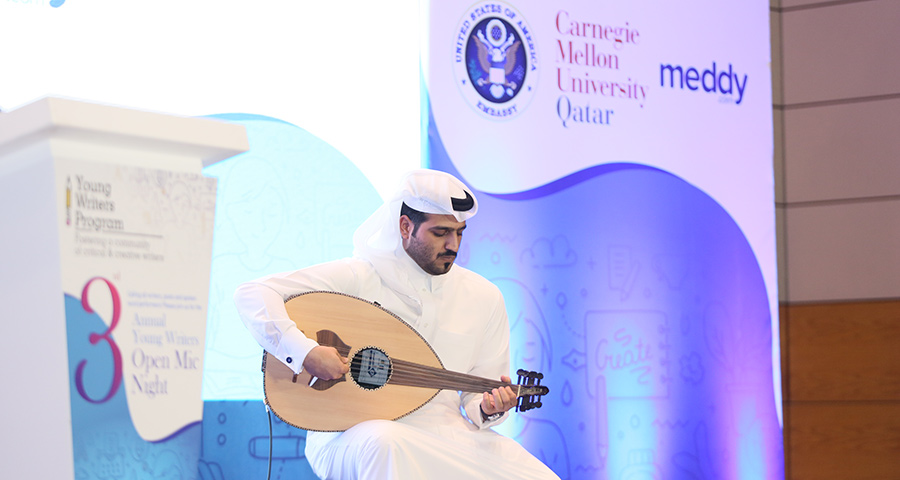 CMU-Q alumnus Abdulla AlKhenji playing the oud at Open Mic Night