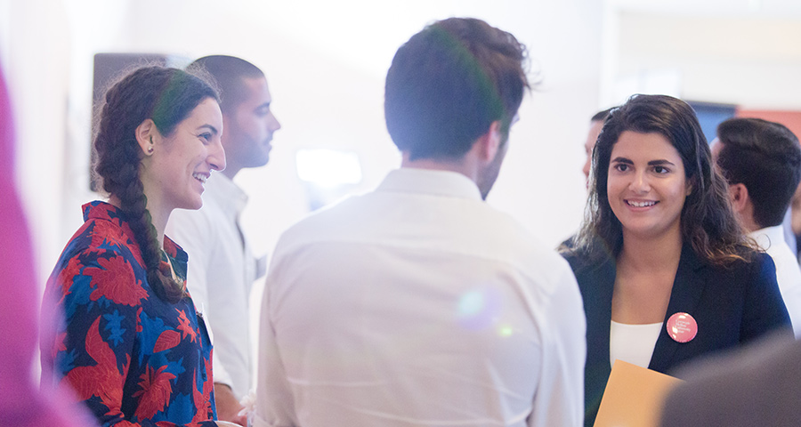 A student networks with consulting firms at Professional Services Day.