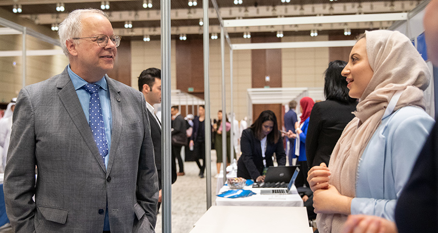 Dean Trick speaks with an alumna at EC Career Fair 2019