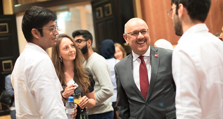 President Farnam Jahanian talks with CMU-Q alumni