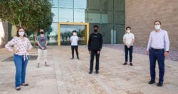 Giselle Reis (left), Eduardo Feo Flushing (right) and students from the winning ICPC Qatar teams  