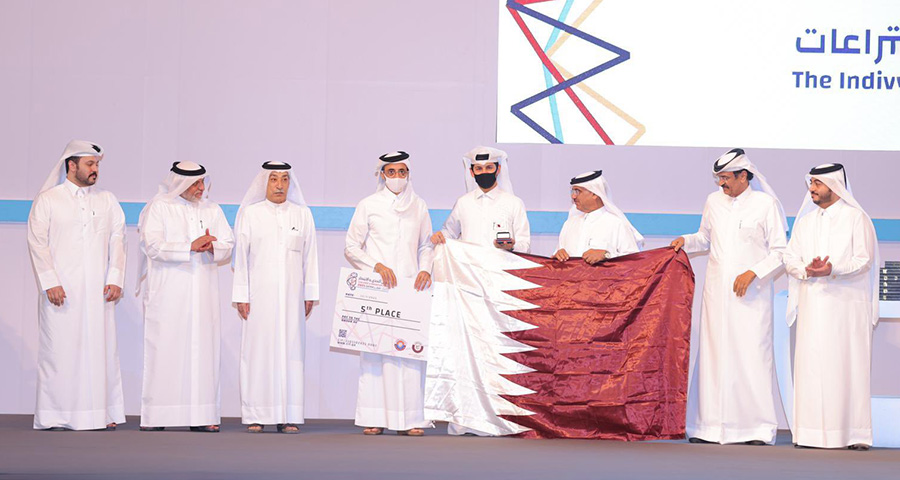 Mohammed Al-Qassabi (center with the black mask) is awarded fifth place at the Challenge and Innovation Forum Qatar 2021.