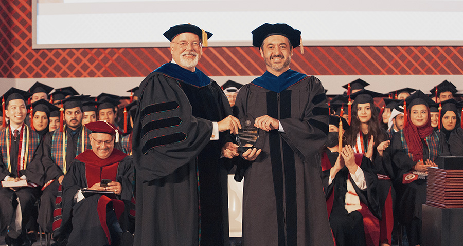 Michael Trick presents Ihab Younis with the Meritorious Teaching Award 2023.