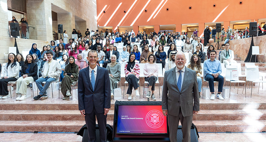 Michael Trick and Dudley Reynolds with students on the Fall 2023 Dean's List.