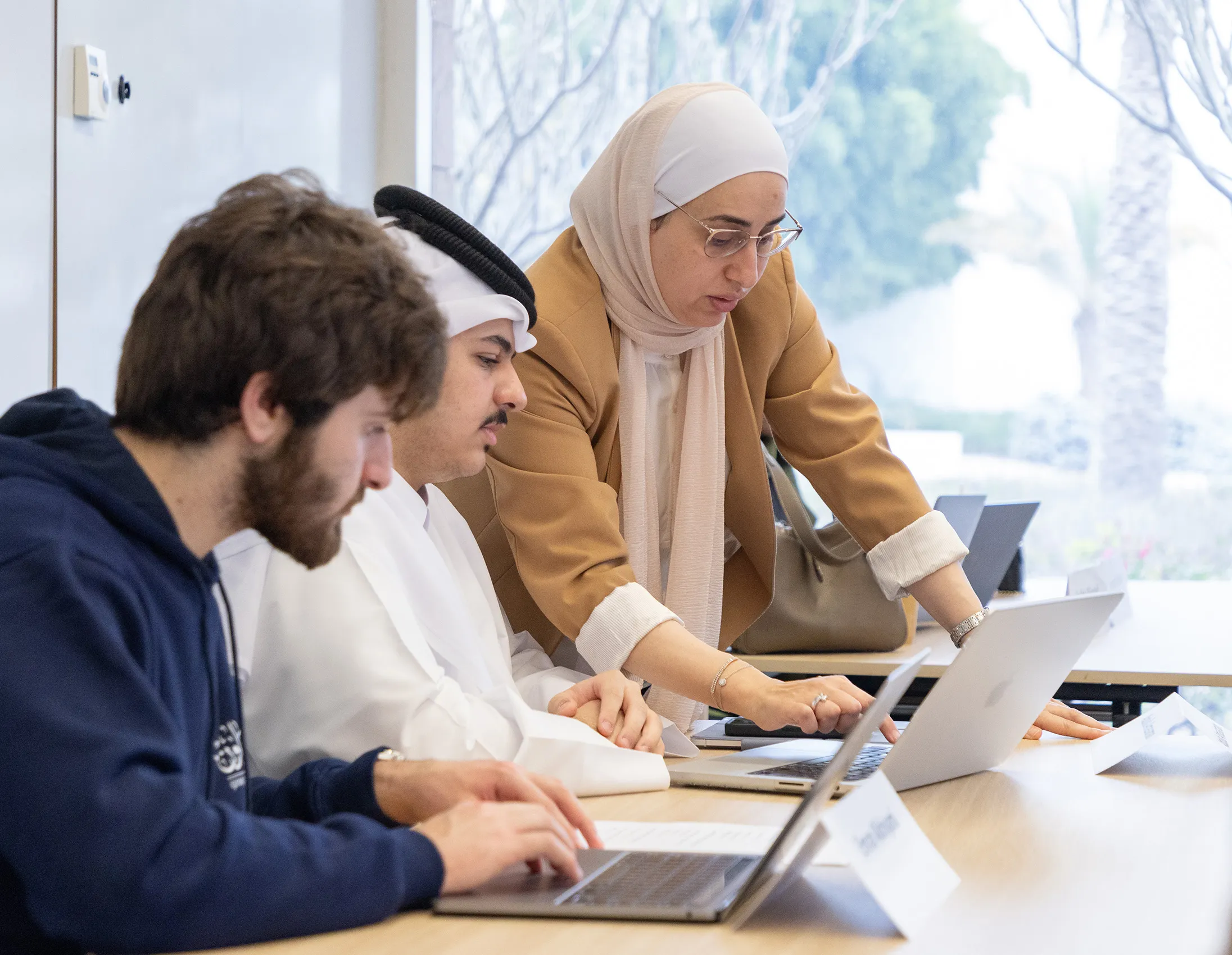 CMUQ business faculty with students in the classroom
