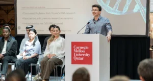 Student standing at podium for CMUQ annual internship showcase 2026