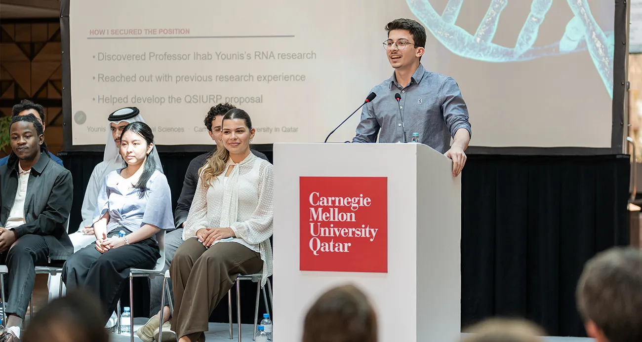 Student standing at podium for CMUQ annual internship showcase 2026
